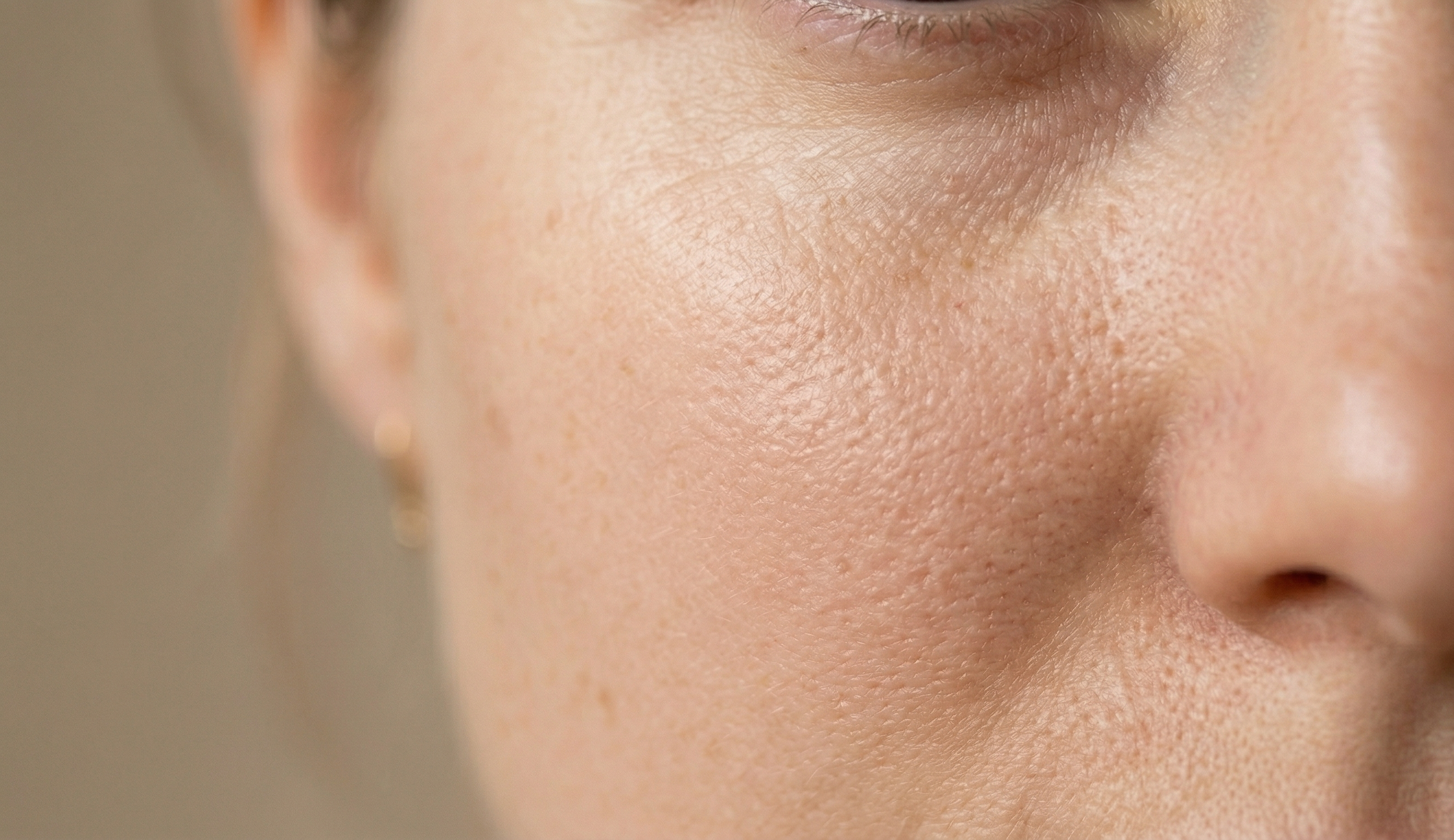 Close-up of a person's face with visible skin texture and pores.